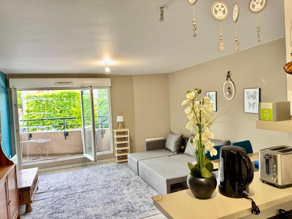 a living room with a couch and a table at AMOUR PARIS -Orly 10min Bus -RER C Tram T9 in Vitry-sur-Seine