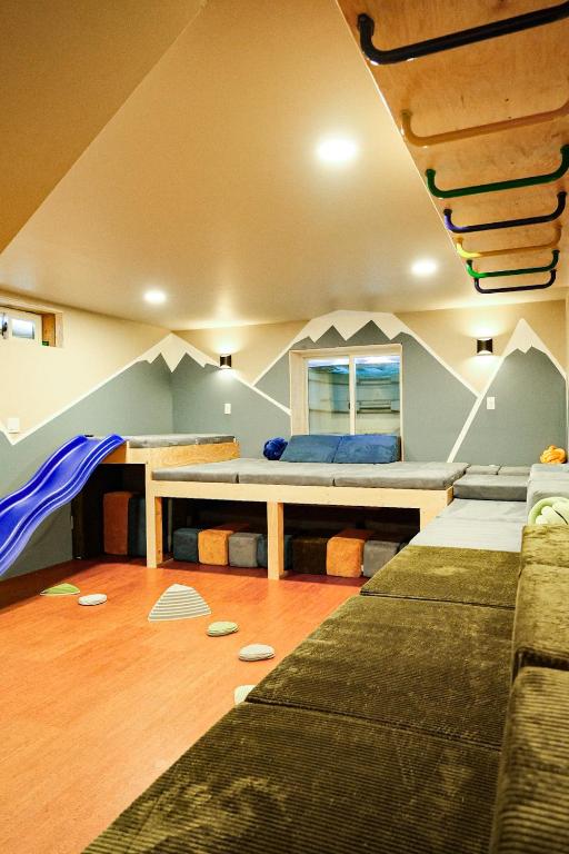 a living room with a bed and a couch at Family Fun Indoor Play Zone UP Waterfalls in Bessemer