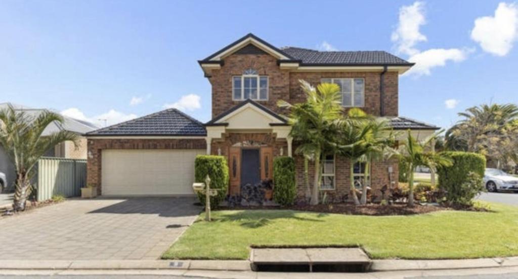 a large brick house with a garage at MawsonLakes Lake view Villa in Mawson Lakes
