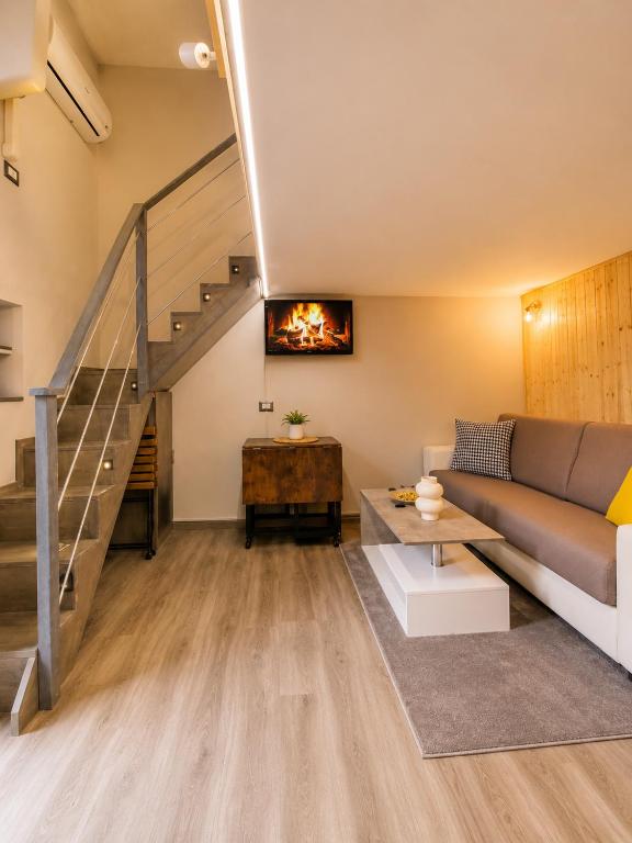 a living room with a couch and a staircase at ZONA NAVIGLI Design Loft , Proiettore schermo 80" in Milan