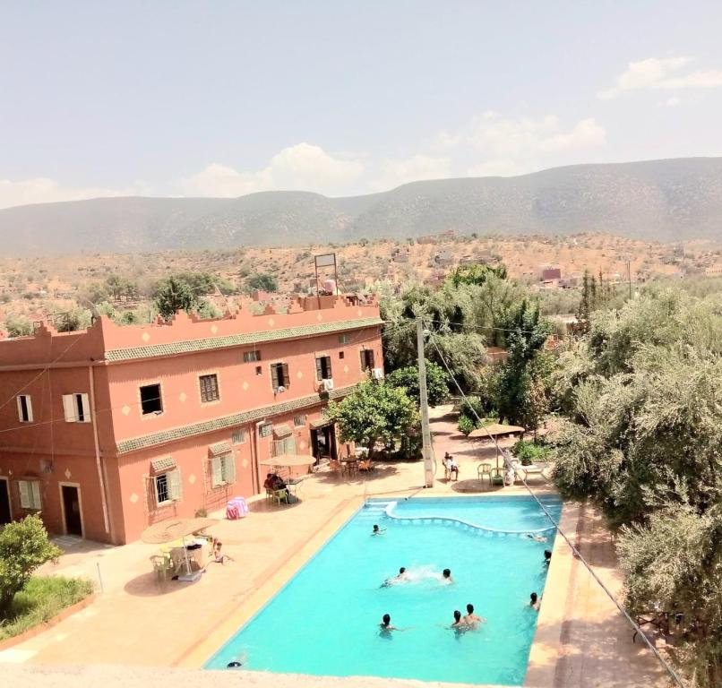 a group of people swimming in a swimming pool at Hotel France Ouzoud in Ouzoud