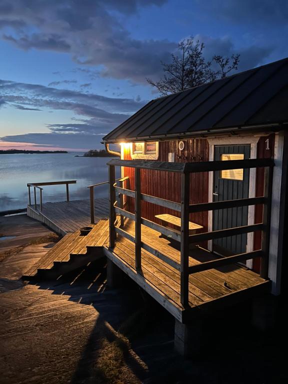 a cabin on a dock with the water in the background at Sandvik Gästhamn & Camping in Kökar