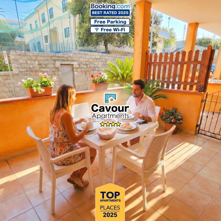 a man and a woman sitting at a table at Cavour Apartment With Terrace in Palau