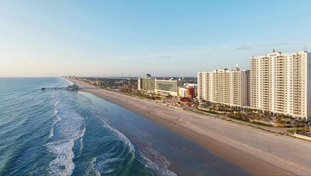 an aerial view of a beach with buildings and the ocean at Ocean Walk Resort in Daytona Beach