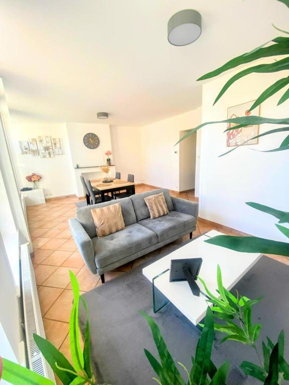 a living room with a couch and a table at Familly Jean Bart-Centre-ville in Dunkerque