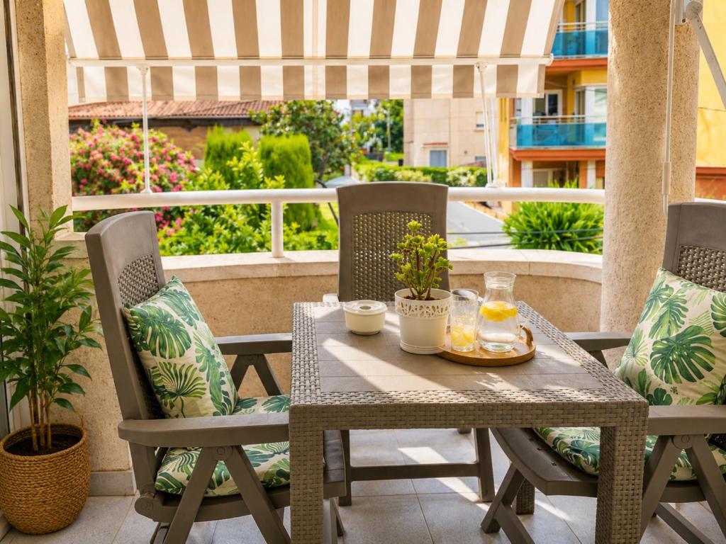 a table and chairs on a patio with a balcony at Tramuntana apart in Calafell