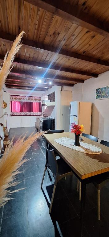a large room with a wooden table and chairs at Paseo Dean Funes Dúplex in San Rafael