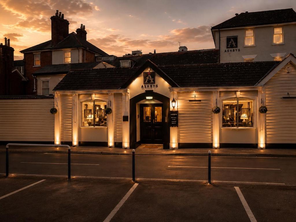 a white building with lights in a parking lot at Ashbys Accommodation & Spa hire in Portsmouth