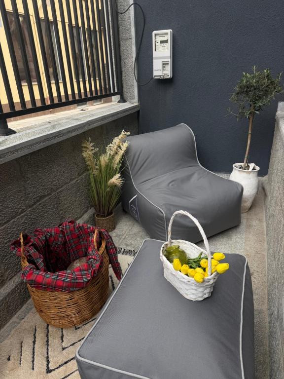 a table with a basket of fruit and a chair at Liams Cozy Villa in Korçë