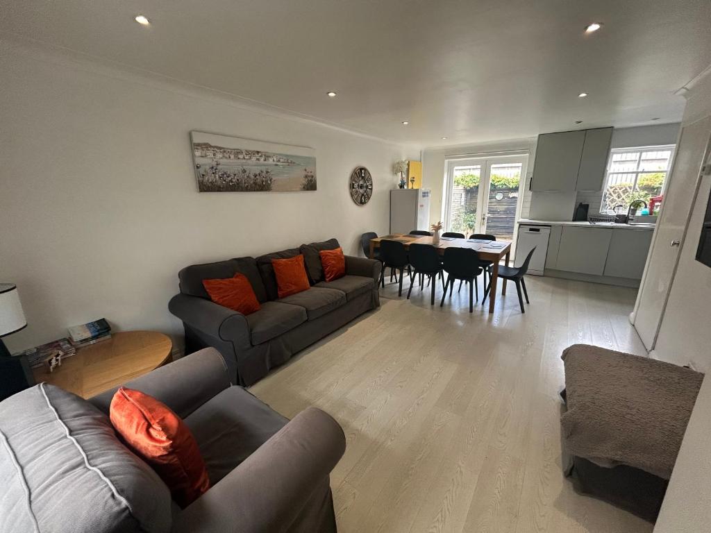a living room with a couch and a dining room at Brighton Central Home with free parking in Brighton & Hove