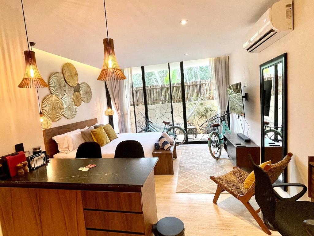 a bedroom with a bed and a table and chairs at Swim up pool Beachclub rooftop in Tulum