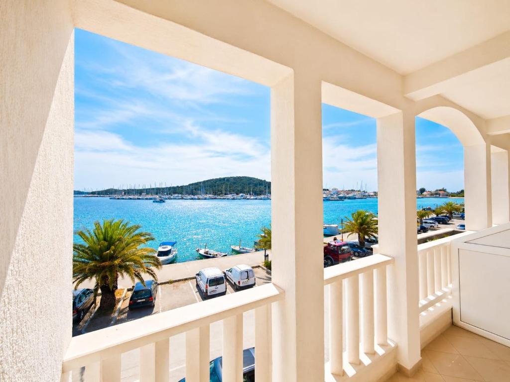 a balcony with a view of the water at Ap AS in Rogoznica
