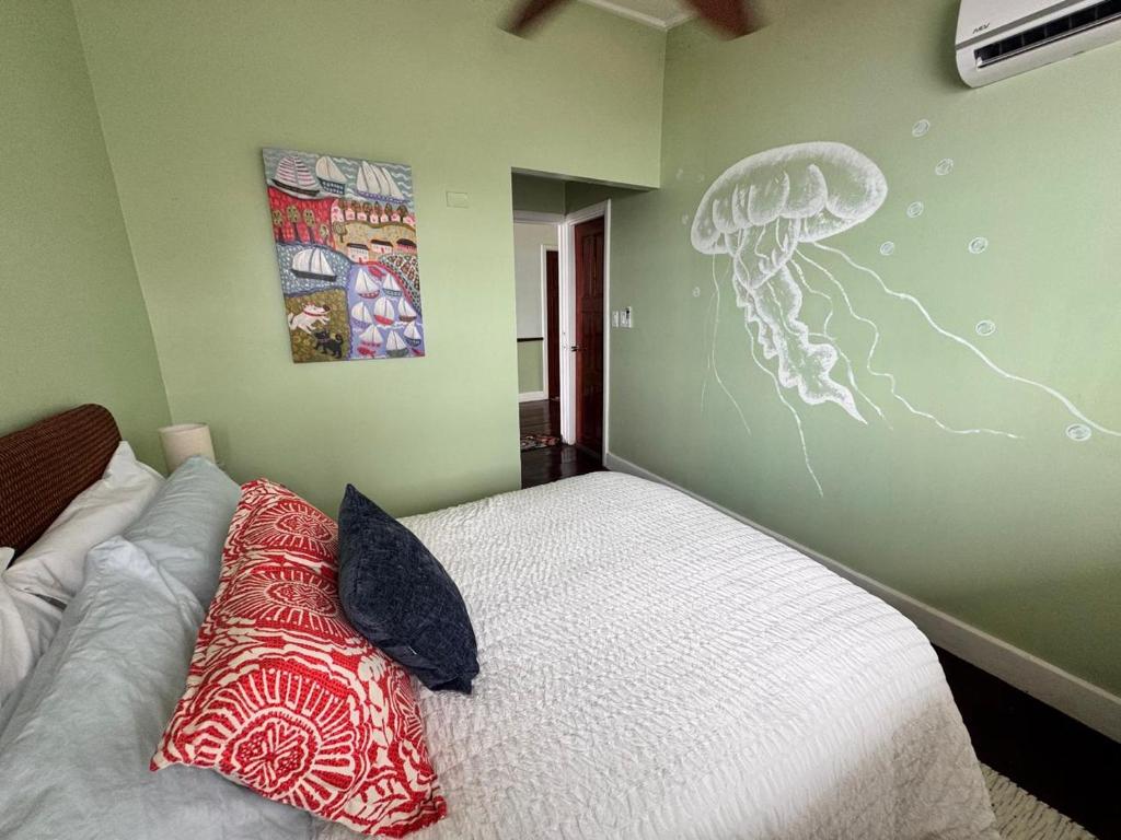 a bedroom with a bed and a wall with a drawing at The Jungle Hotel and Bar in Bocas Town