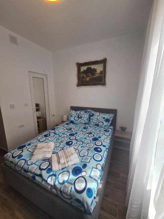 a bedroom with a bed with a blue comforter at Rusu Sirianu rooms in Timişoara
