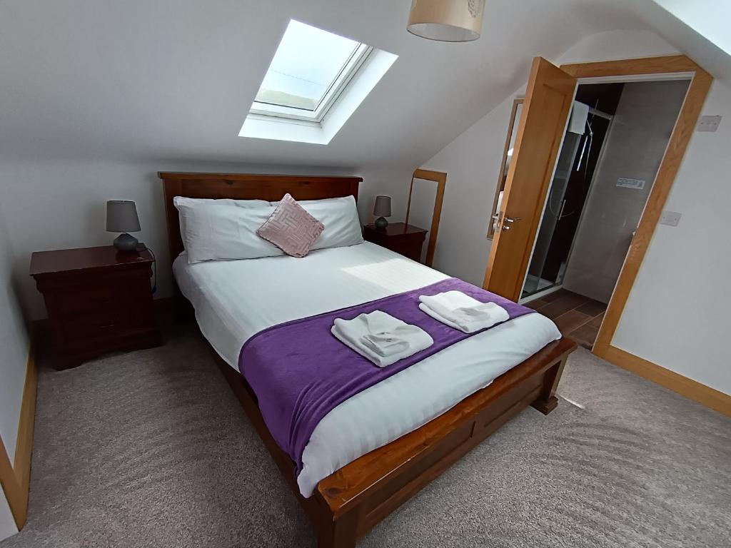 a bedroom with a bed with two towels on it at Radharc soiléir in Doolin