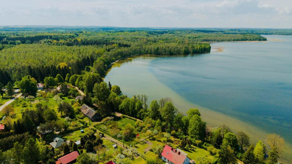 an aerial view of a lake with trees and houses at Apartamenty Fuleda nad jeziorem Dobskim Mazury Holiday in Fuleda