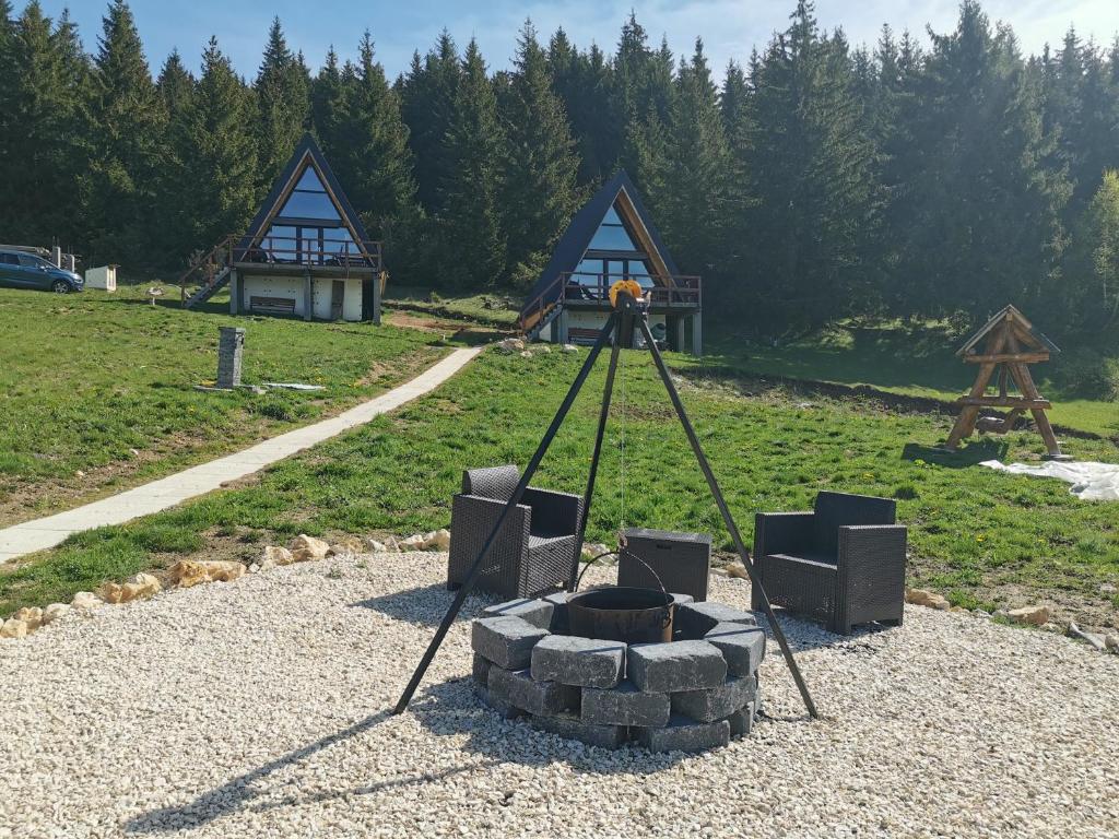 a camera on a tripod with chairs and a fire pit at AA Frame Retreat Fundata in Fundata