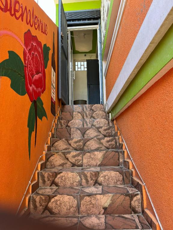 a staircase with a flower painted on the side of a building at BAYO HOTEl in Cap-Haïtien