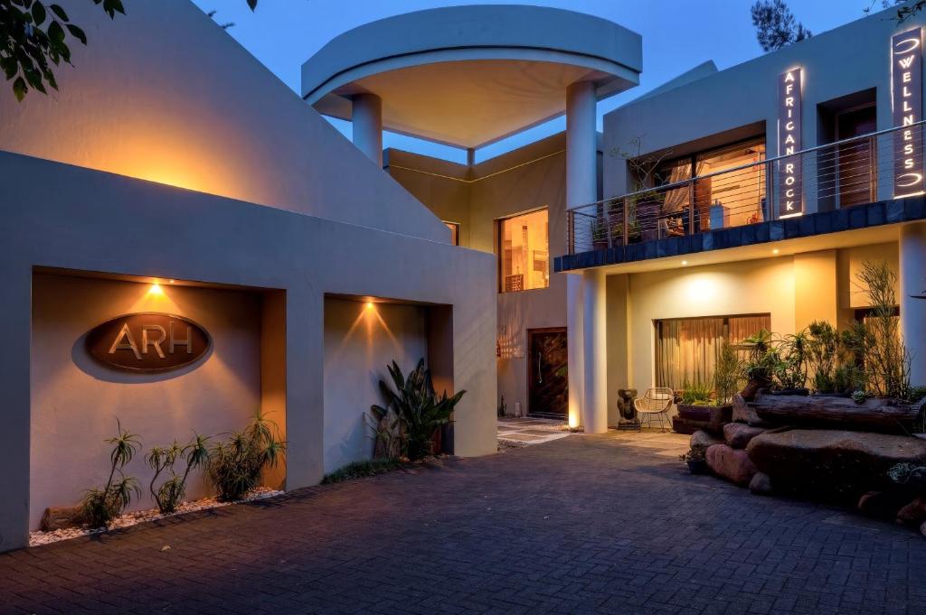 a house with a sign on the side of it at African Rock Hotel & Spa -"Relaxed Exclusivity" in Kempton Park