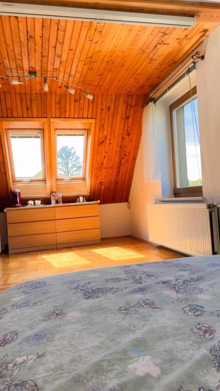 a room with a bed and two windows in it at Your home in Gohrisch in Kurort Gohrisch