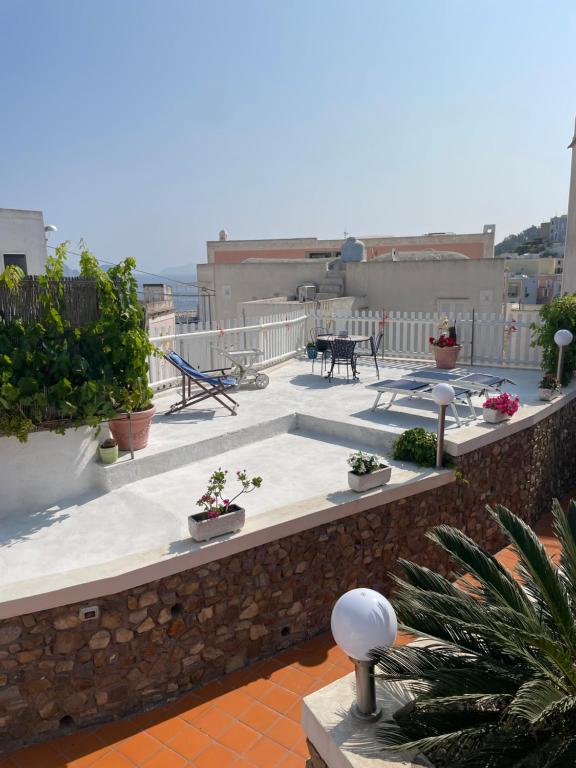 a balcony with plants and a table on a building at La Vite in Ponza