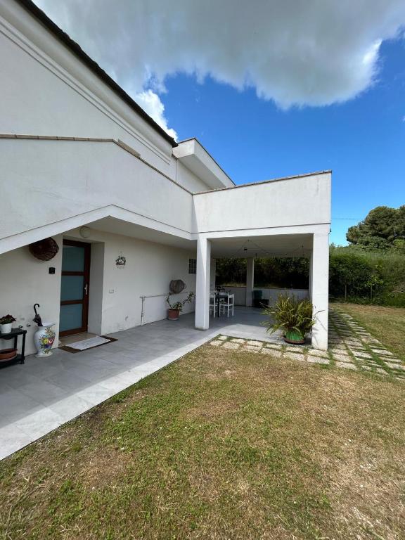 a white building with a patio and a yard at Da Lucia in Francavilla al Mare