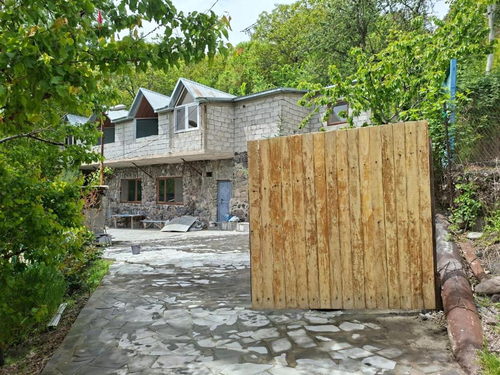 a wooden gate in front of a house at Адами Драхт in Garni
