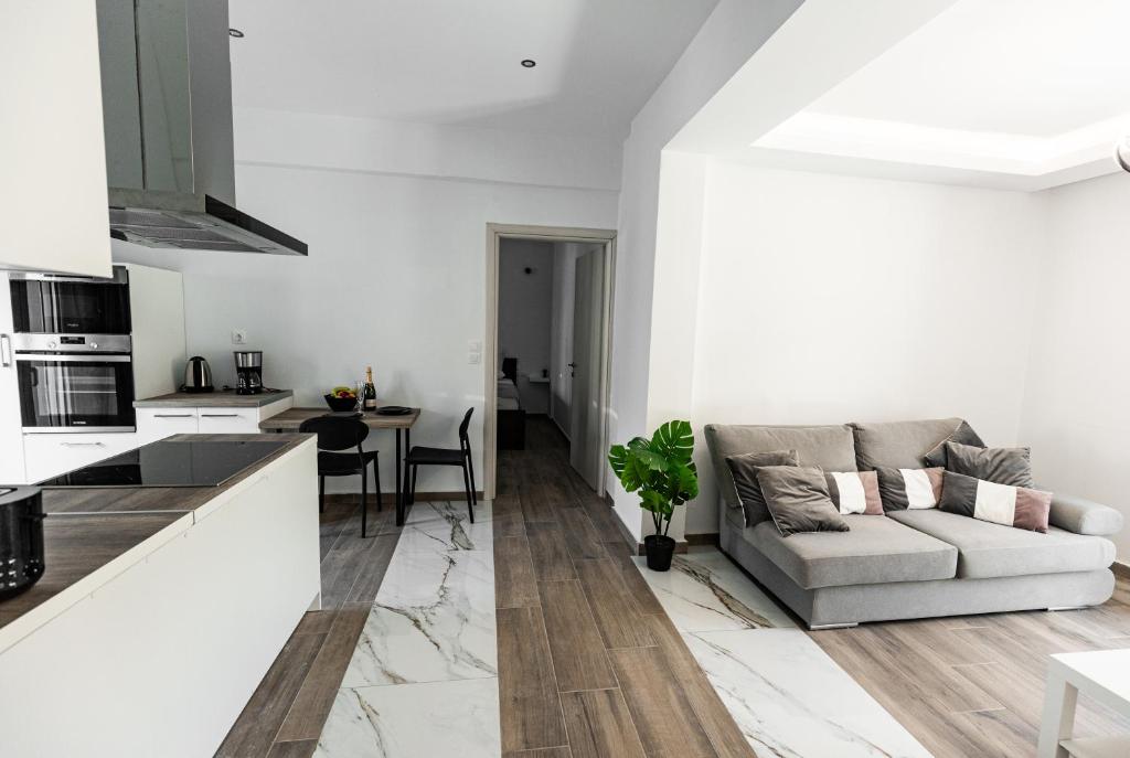 a white living room with a couch and a table at Exclusive suite in Hersonissos