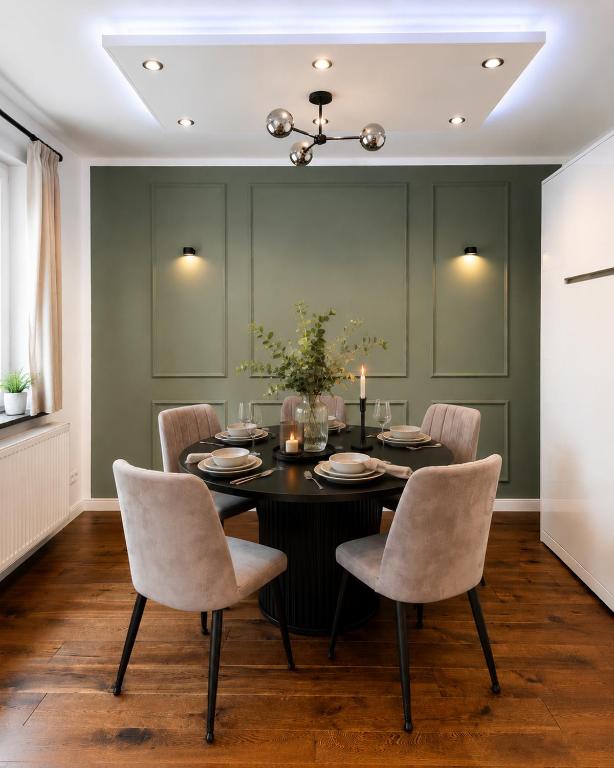 a dining room with a black table and chairs at Modernes Designer-Apartment in ruhiger Lage in Soltau