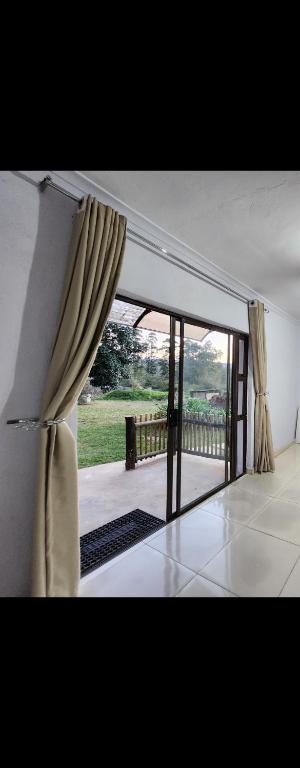 a room with a window with a view of a patio at Mon Desir Estate - NR3 in Pietermaritzburg