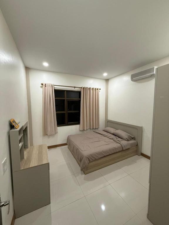 a bedroom with a bed and a window at Happy day in Nong Prue
