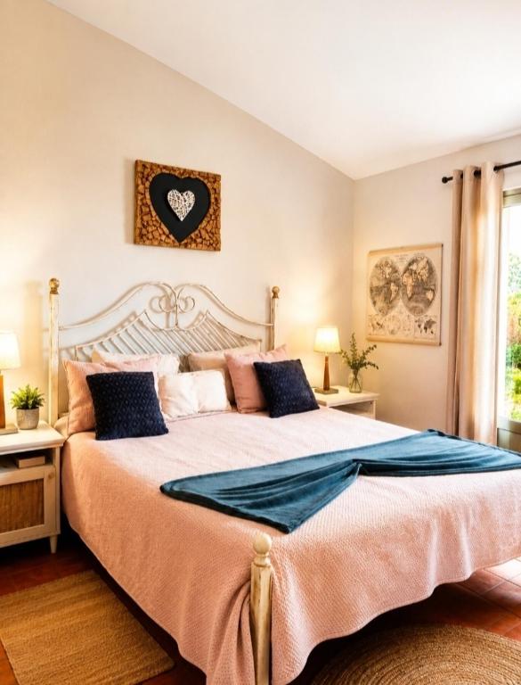 a bedroom with a large bed with a heart on the wall at Casa à Porta do Torreão in Silves