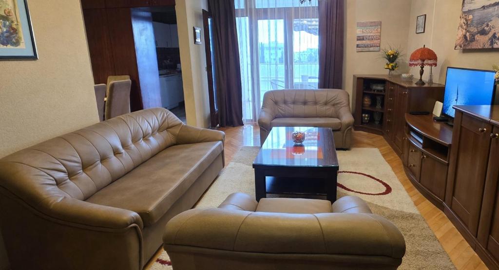 a living room with a couch and a table at Bar Central Point - 2BR Apartment in Bar