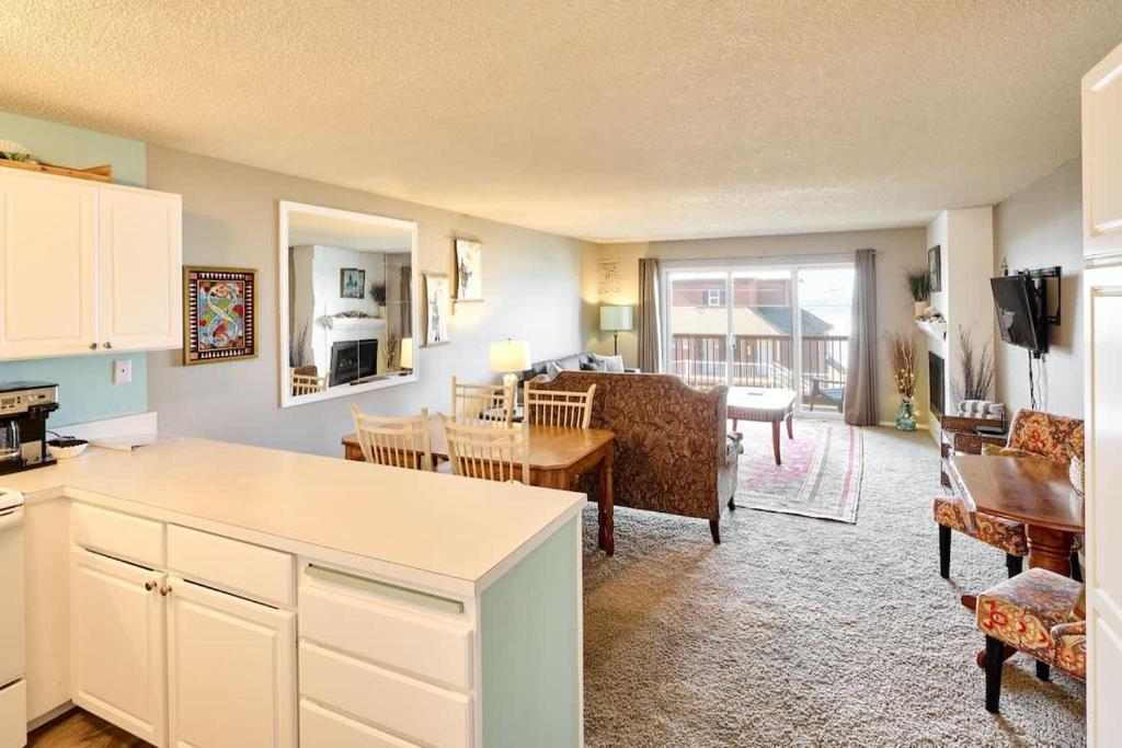 a living room with a kitchen and a dining room at Ground Floor - Ocean View Condo - Pet-Friendly in Lincoln City