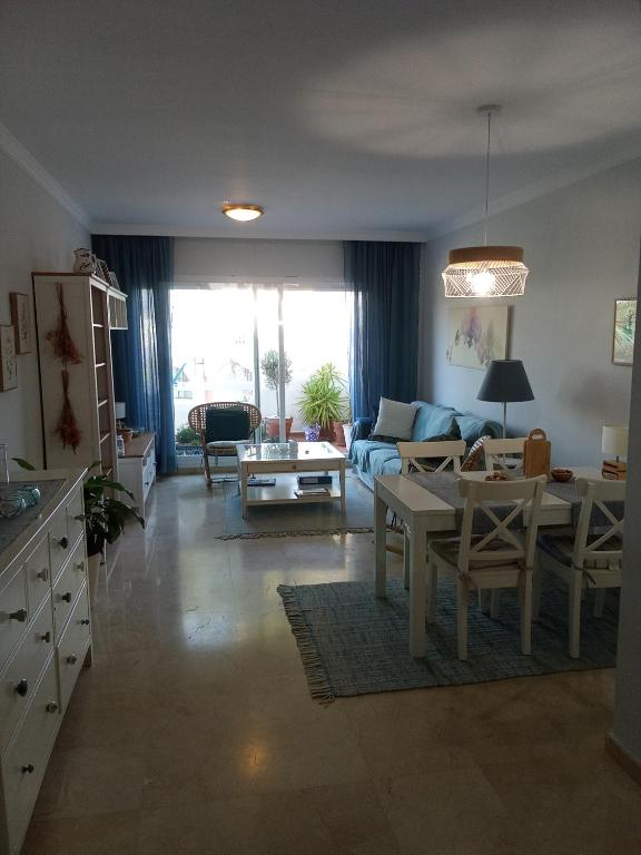 a living room with a couch and a table at Elviria Beauty by the sea in Marbella