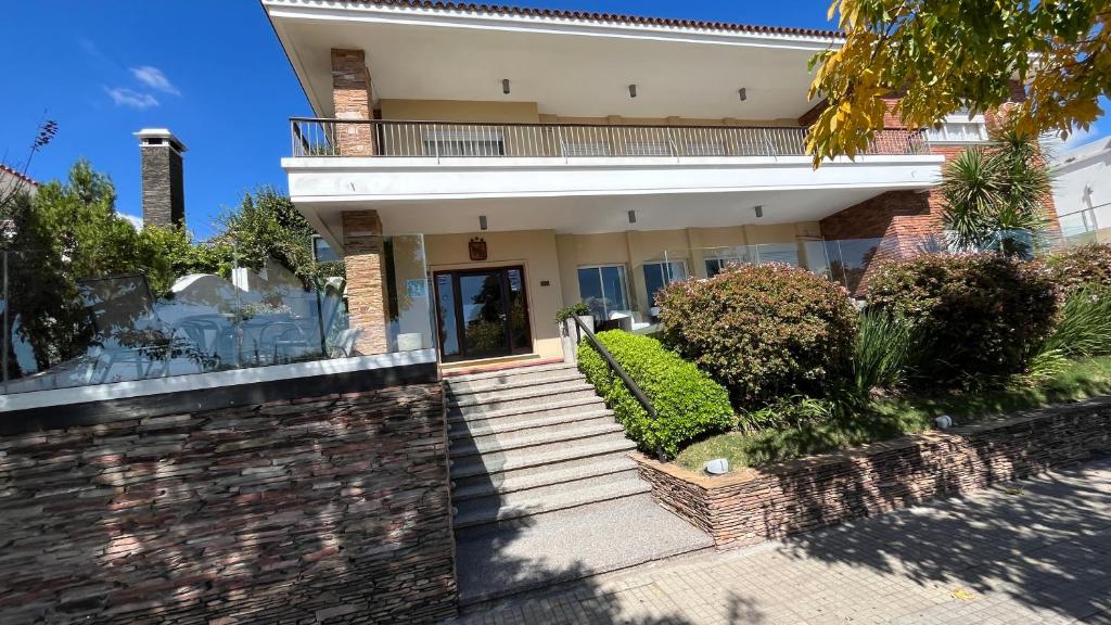 a house with a staircase leading to the front door at Mercedes Rambla Hotel in Mercedes