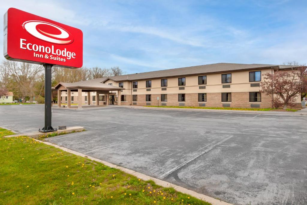 a sign in a parking lot in front of a building at Econo Lodge Inn & Suites Oconto in Oconto