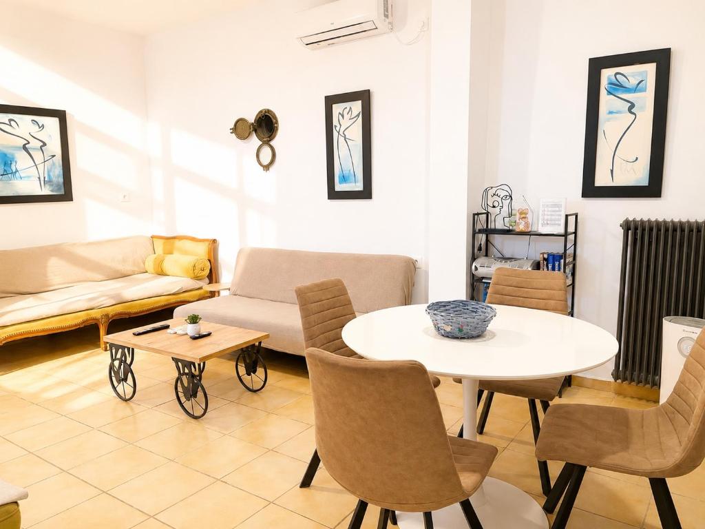 a living room with a table and a couch at Navigo house Vrachati in Vrachati
