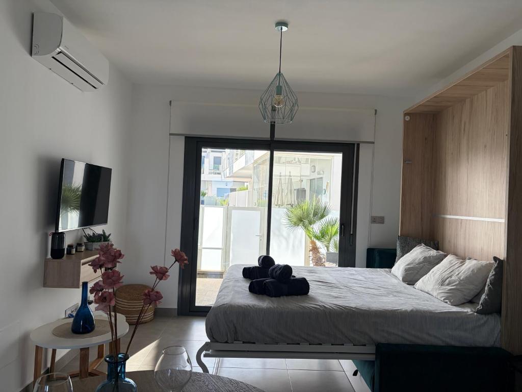 a bedroom with a large bed and a large window at Modern Studio Lamar Resort in Pilar de la Horadada