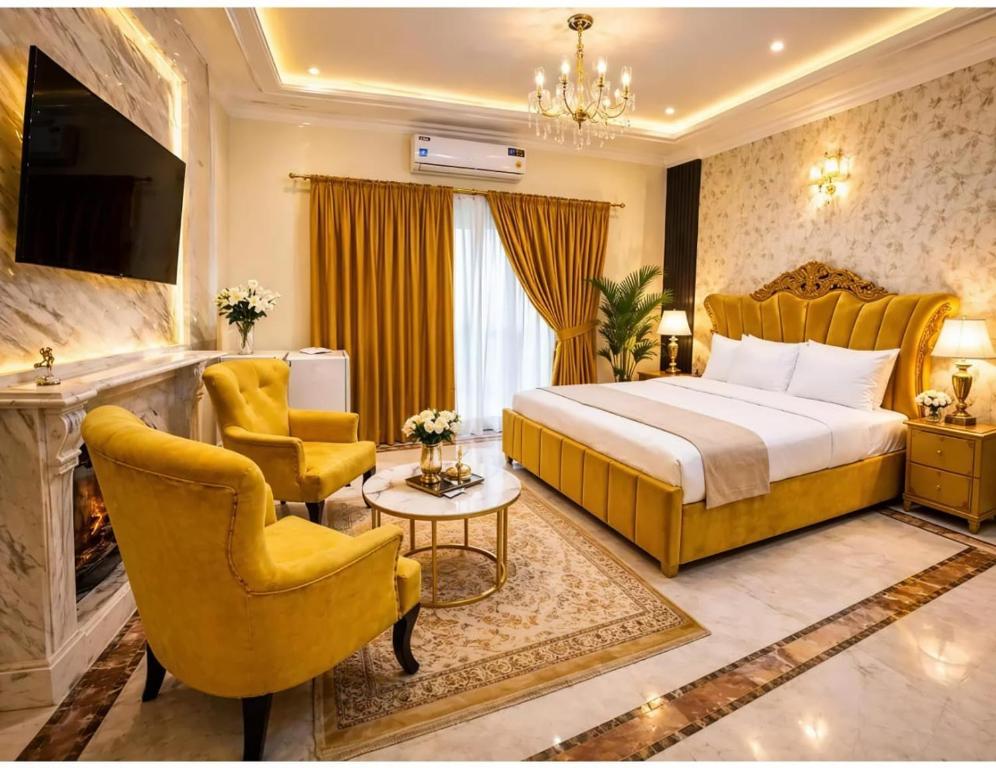 a hotel room with a bed and two chairs at Super Lodge by HFI in Islamabad