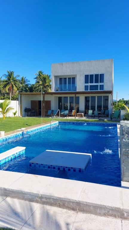 a large swimming pool in front of a house at Venice House, Costa del Sol in San Luis La Herradura