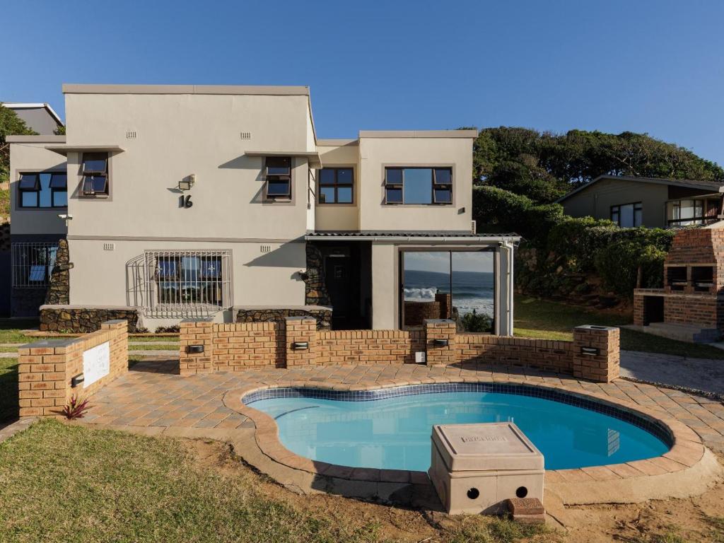 a house with a swimming pool in front of it at La Vue in Port Shepstone