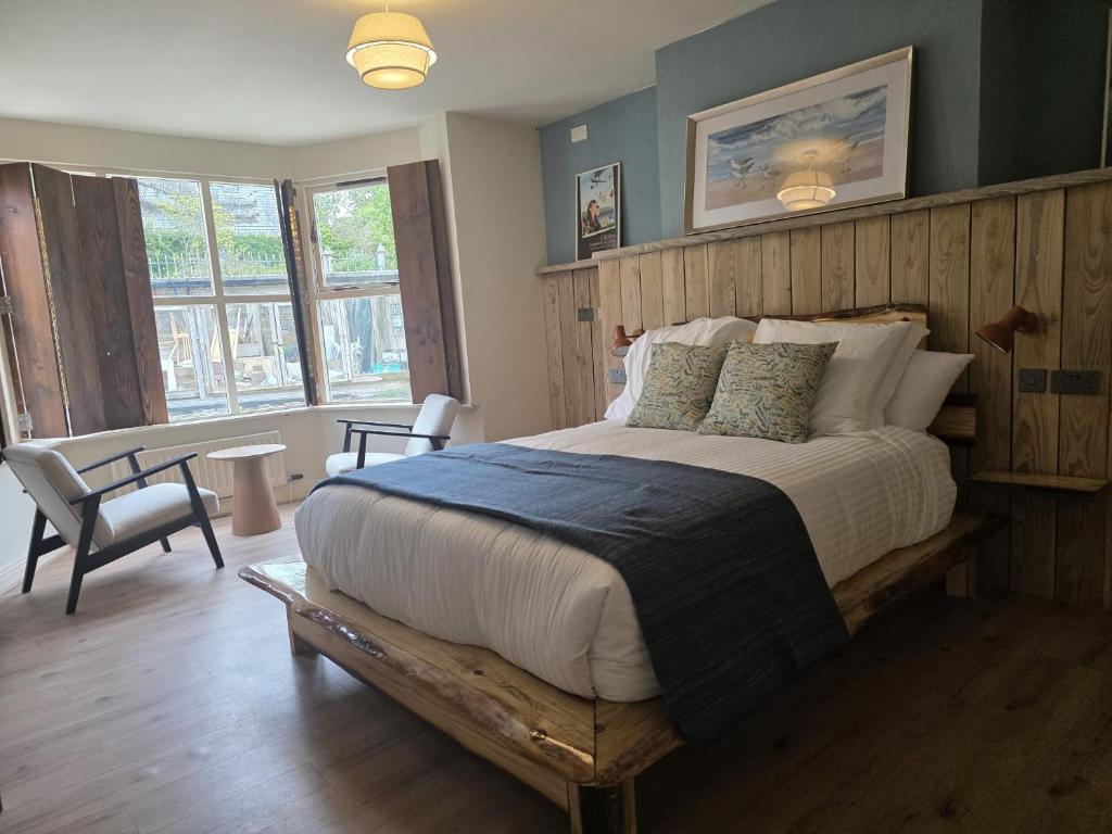 a bedroom with a large bed with a wooden headboard at Connemara National Park Lodge in Letterfrack