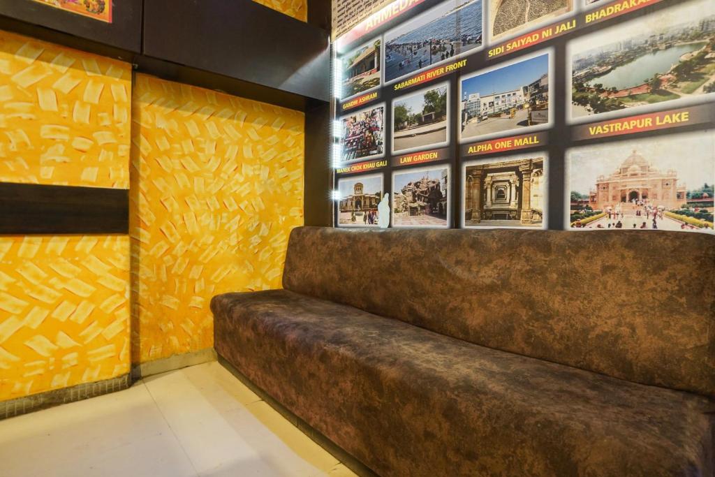 a staircase in a building with pictures on the wall at Hotel O Crystal in Ahmedabad