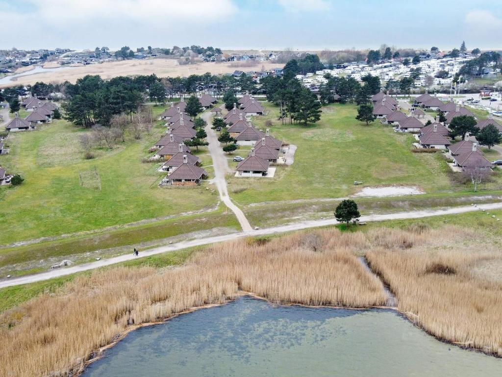 an aerial view of a village with houses and a river at Coastal Bungalows with Beach Access in Karrebæksminde