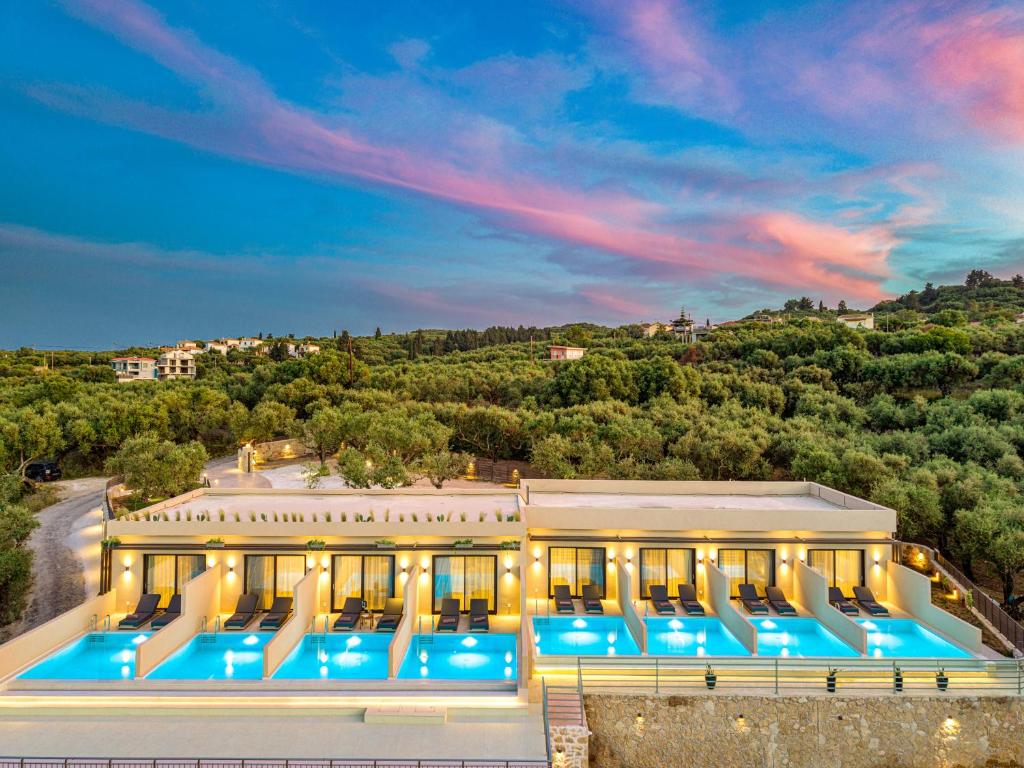 an aerial view of a building with a pool at Helena's Aether Suites - Seaview & Heated Infinity Pool in Tragaki