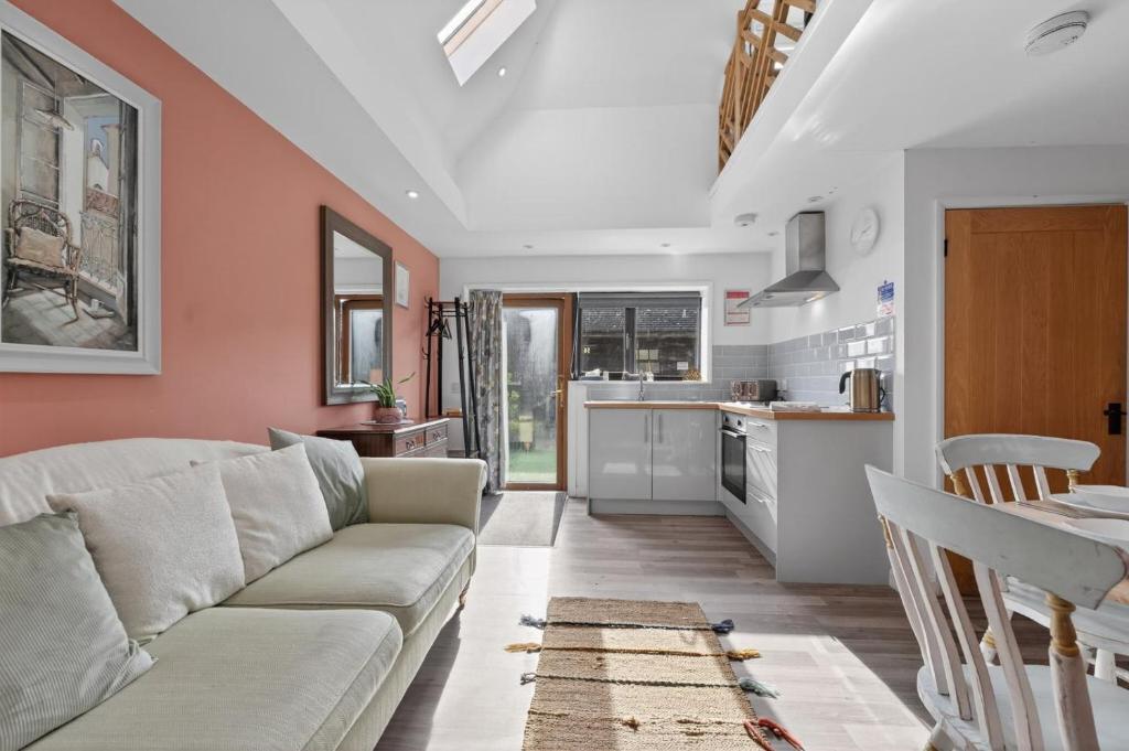 a living room with a couch and a kitchen at 1 Bed in Alkham oc-s34788 in Swingfield