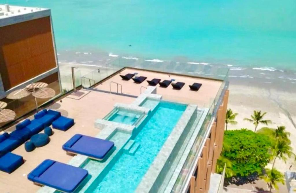 an aerial view of a resort with a swimming pool and the beach at New Time 304 Maceió Alagoas in Maceió