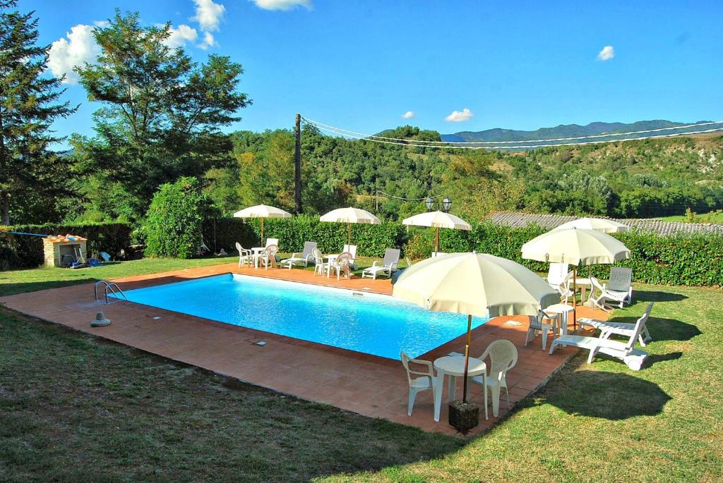 einen Pool mit Stühlen und Sonnenschirmen im Hof in der Unterkunft Villa Marisel in Gricignano