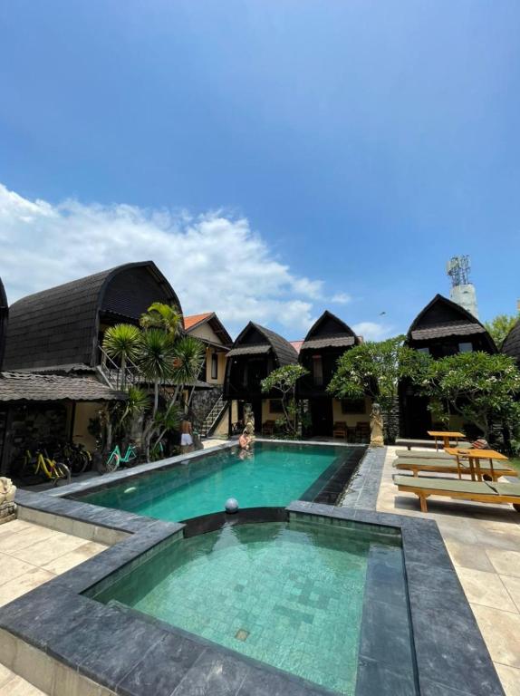 a swimming pool at a resort with a resort at Bale Sasak Bungalow in Gili Trawangan